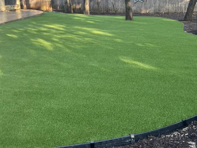 green turf recently installed in a backyard